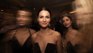 Woman in an evening gown looking into the camera at an upscale event